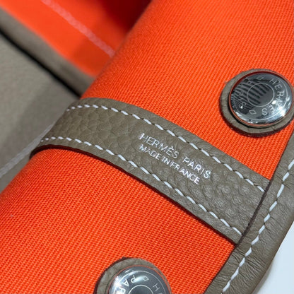 GARDEN PARTY 30CM IN ORANGE MINIMUM TOILETS COTTON CANVAS AND BROWN CALFSKIN